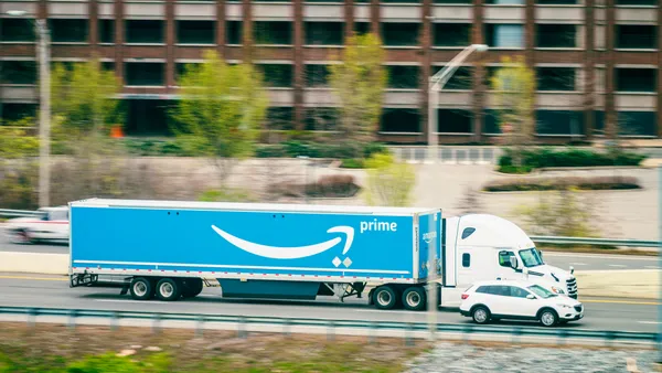 A side view of a large Amazon Prime tractor-trailer, with motion blur on the background as it passes on Interstate 40 in Nashville, Tennessee.