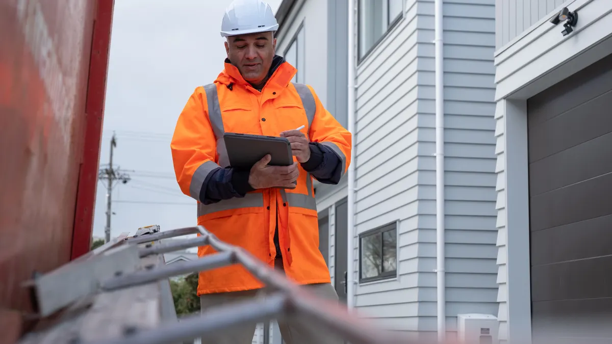 A Site Manager Checking His Reports