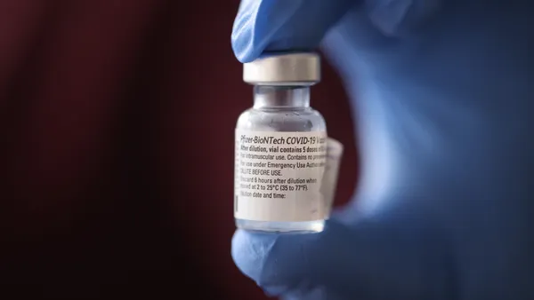 A nurse shows a container of Pfizer-BioNTech COVID-19 vaccine after it was used to vaccinate the first five staff members at Roseland Community Hospital on December 17, 2020 in Chicago, Illinois.