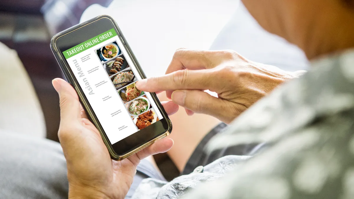 Ordering takeout and delivery convenience food from an online Asian restaurant delivery meal from a smart phone.