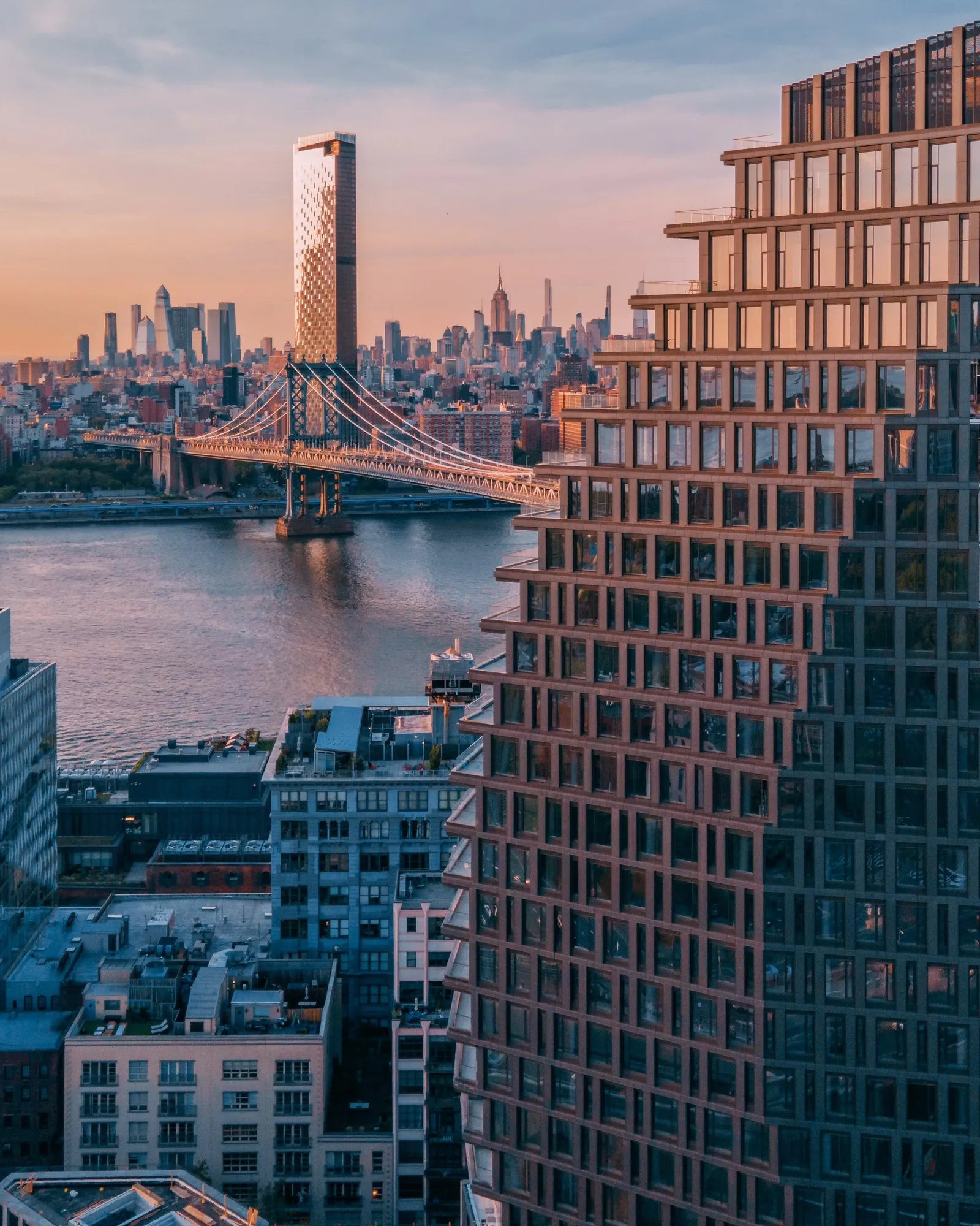 An apartment tower, rising above a bridge.