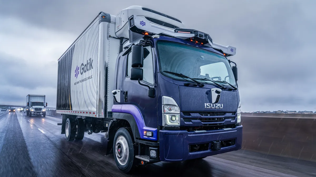 An Isuzu-Gatik truck on the highway.