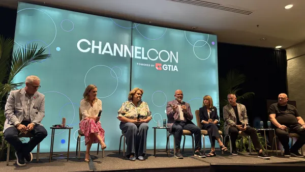 seven people sitting on a slightly raised stage