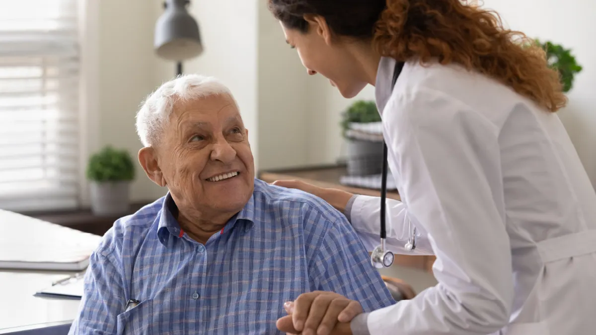 Doctor tending to elderly patient