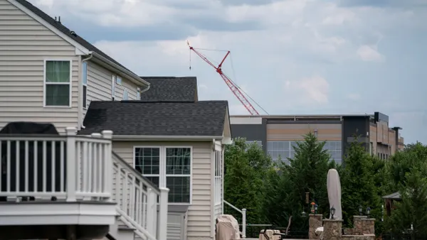 An Amazon Web Services data center is shown situated near single-family homes