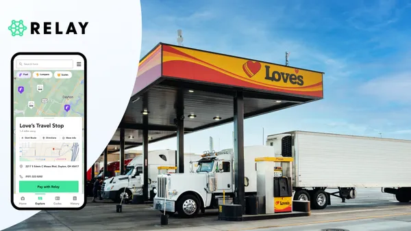 A photo of 18-wheel trucks at diesel fuel pumps. the canopy over the pumps says Love's. A mobile phone is superimposed over part of the left side of the picture, showing a map of the area around Dayton, Ohio, with the words "Love's Travel Stop."