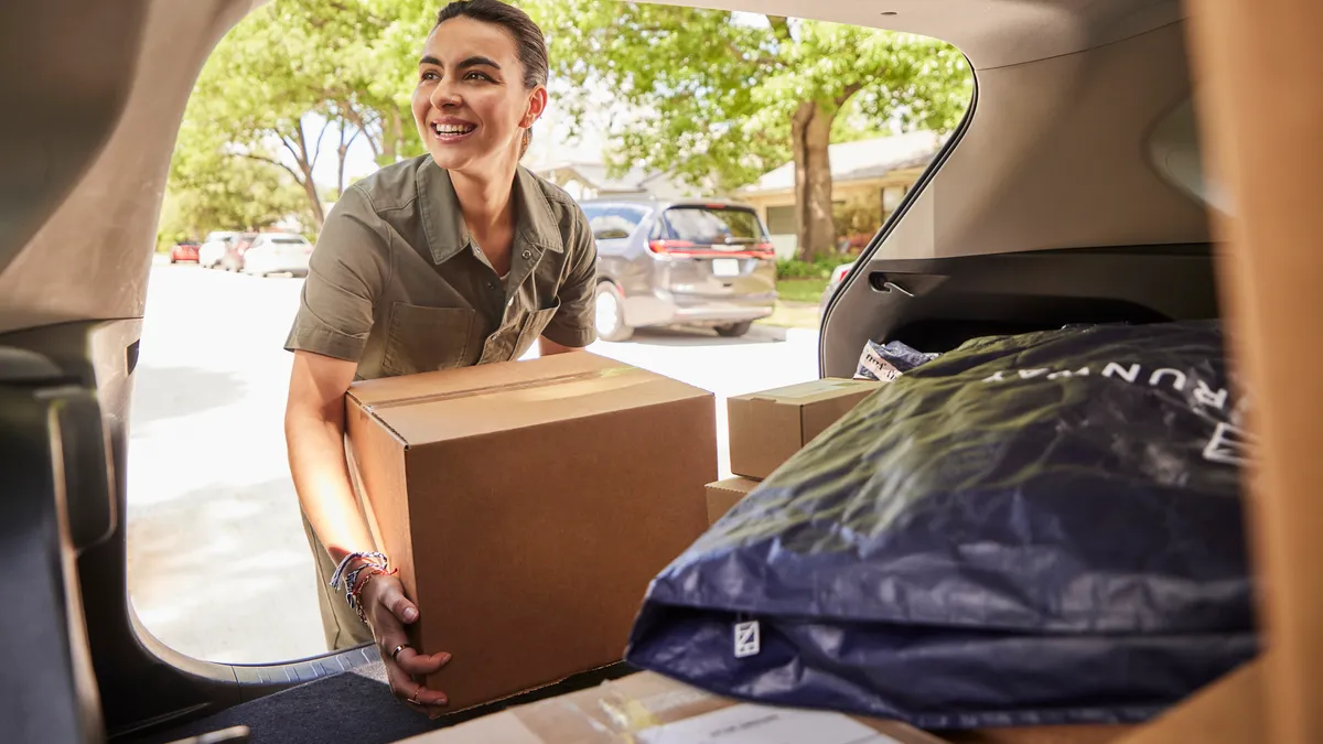 Delivery woman holding box