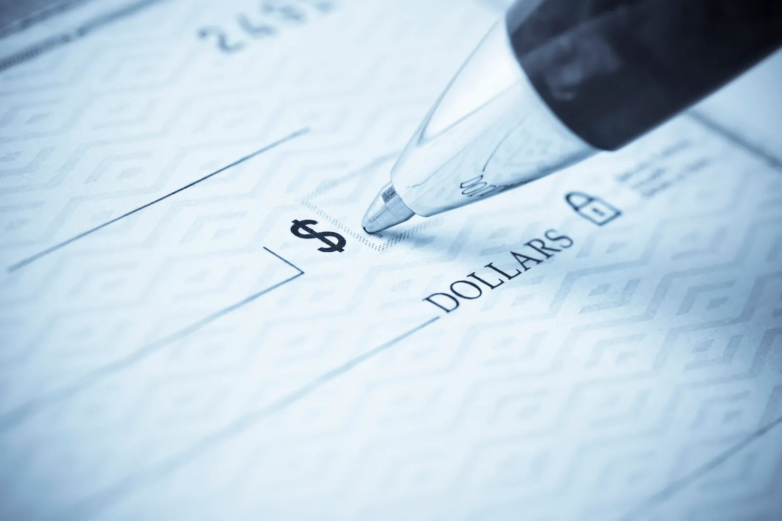 A person writes on a check.