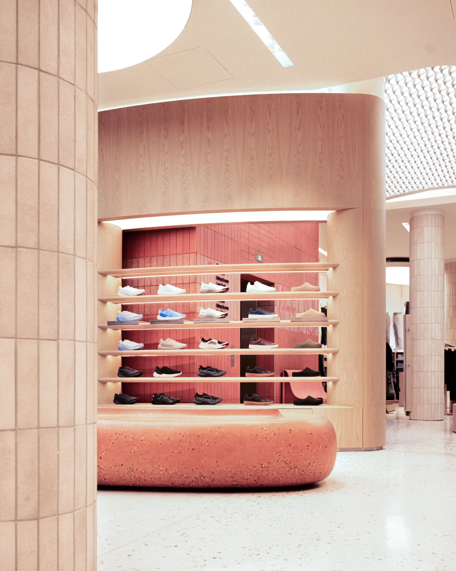 A rack of shoes in a brightly lit store.