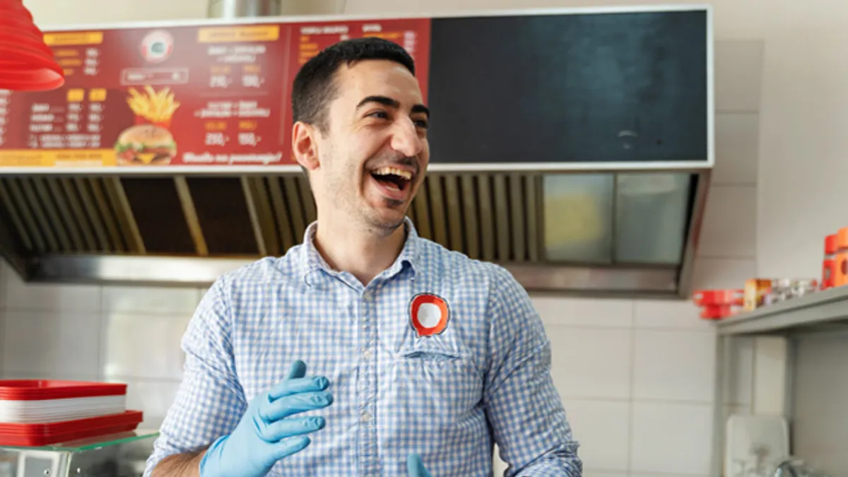 Chef in kitchen smiling