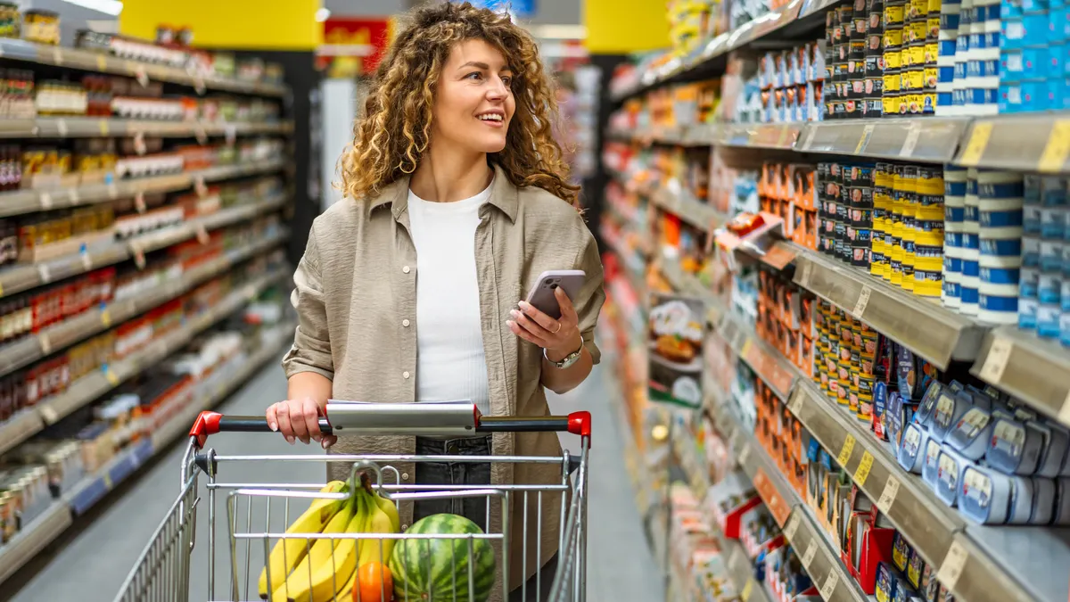 Woman checking a shopping list on the smartphone