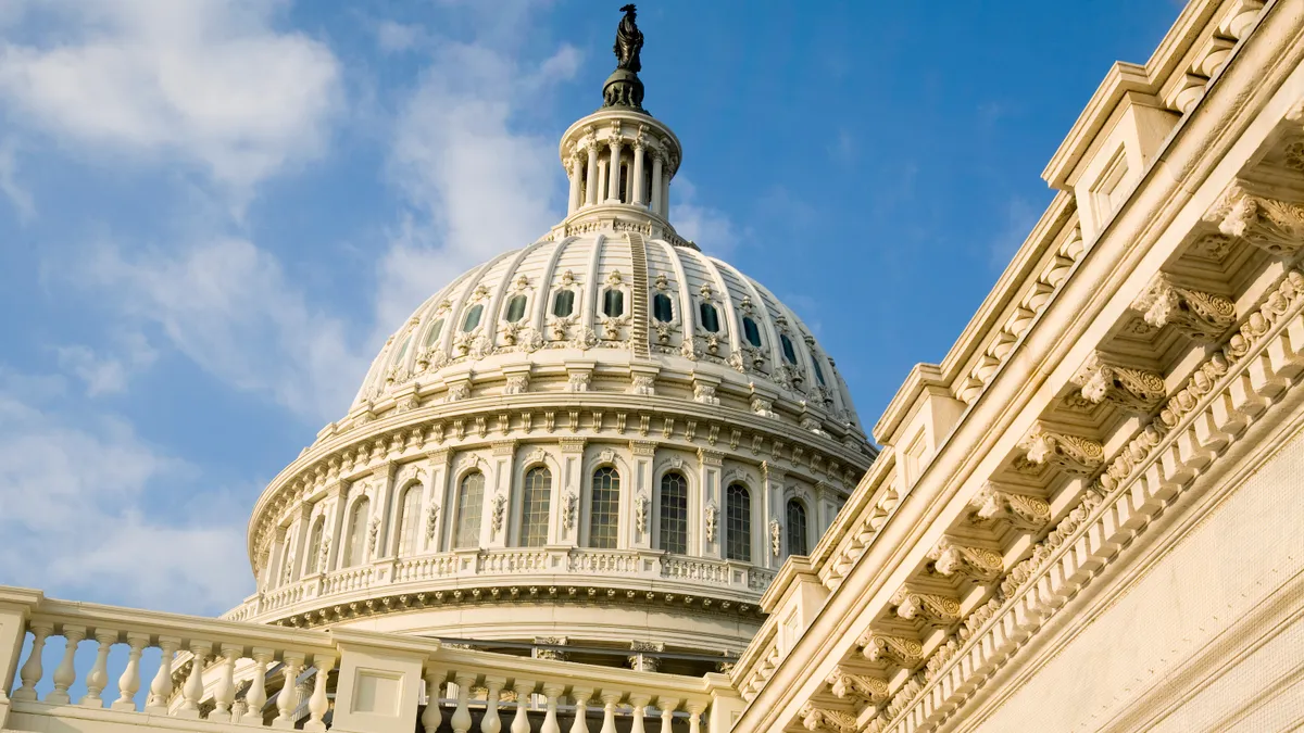 Close shot of the U.S. Capitol dome against the bright blue sky.