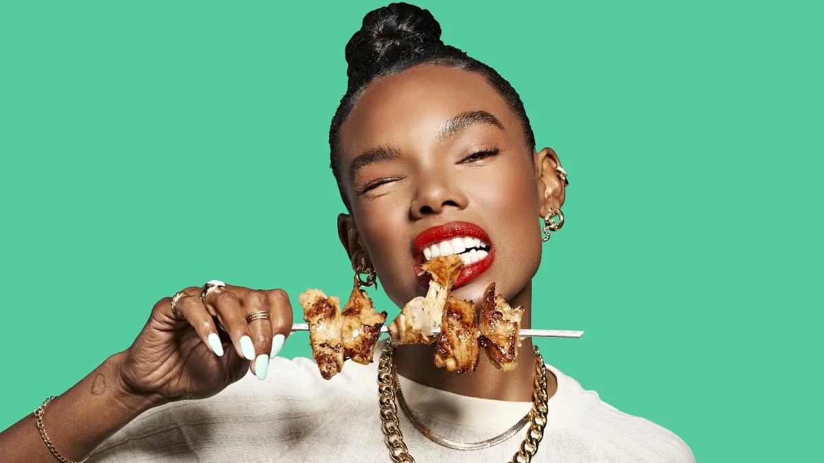 A woman eating Daring Foods' plant-based chicken