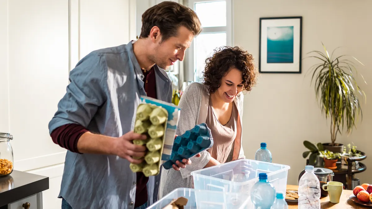 Close up of a young couple collecting recyclables in the morning