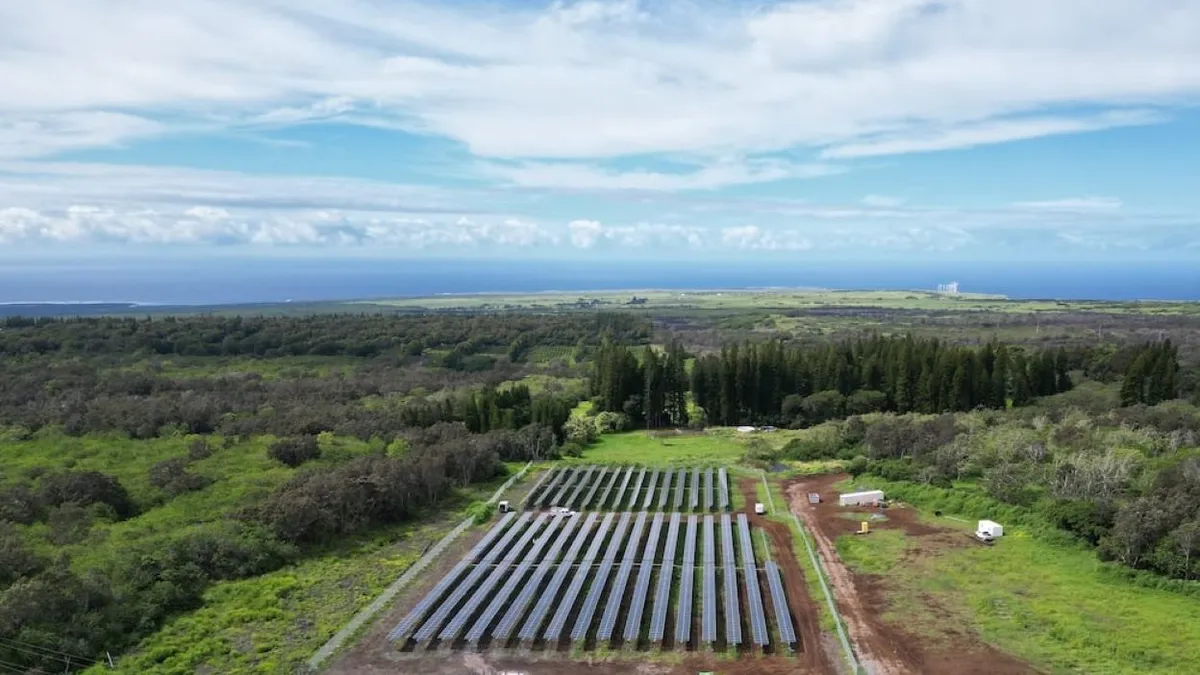 A solar farm as seen from above on a sunny day.