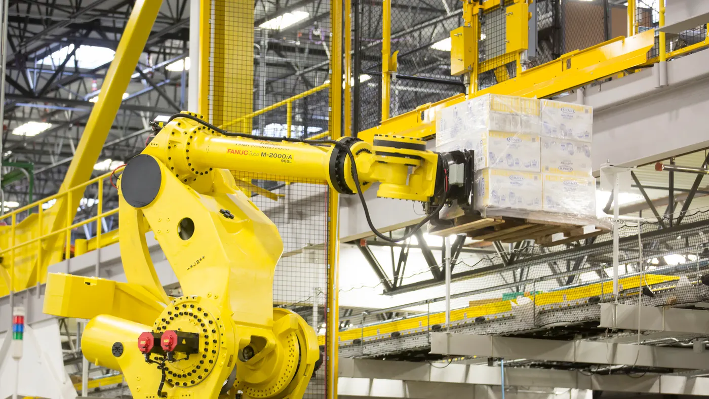 A robotic arm lifts a pallet of merchandise inside an Amazon Fulfillment Center on Feb. 13, 2015 in DuPont, Washington.