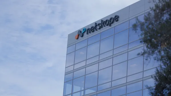 glass-windowed office building titled Netskope