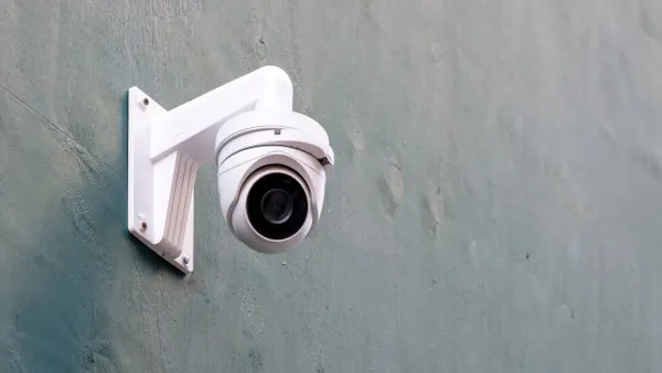 Security Camera on gray wall, CCTV surveillance system equipment