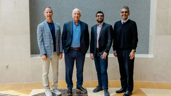 Members of Vedana's executive team and board pose for a photo.