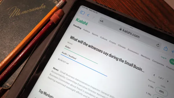 A tablet displays the Kalshi prediction-markets app.