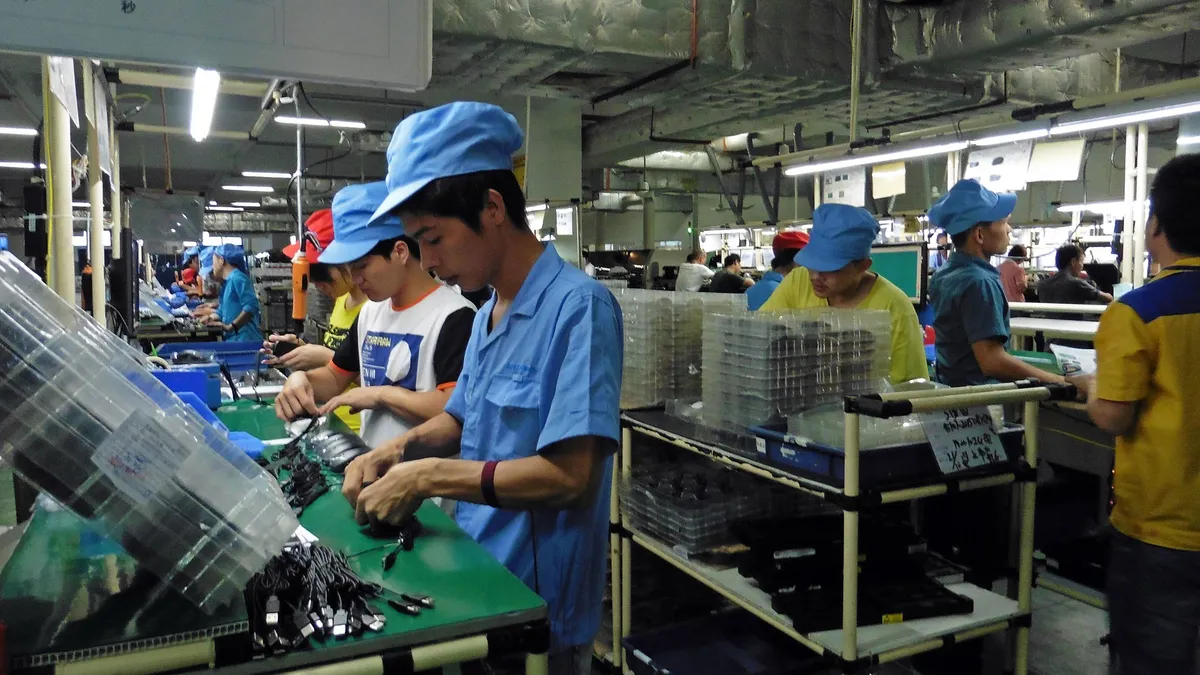 Workers assemble tech accessories at G.Tech Technology Factory in Zhuhai, China.