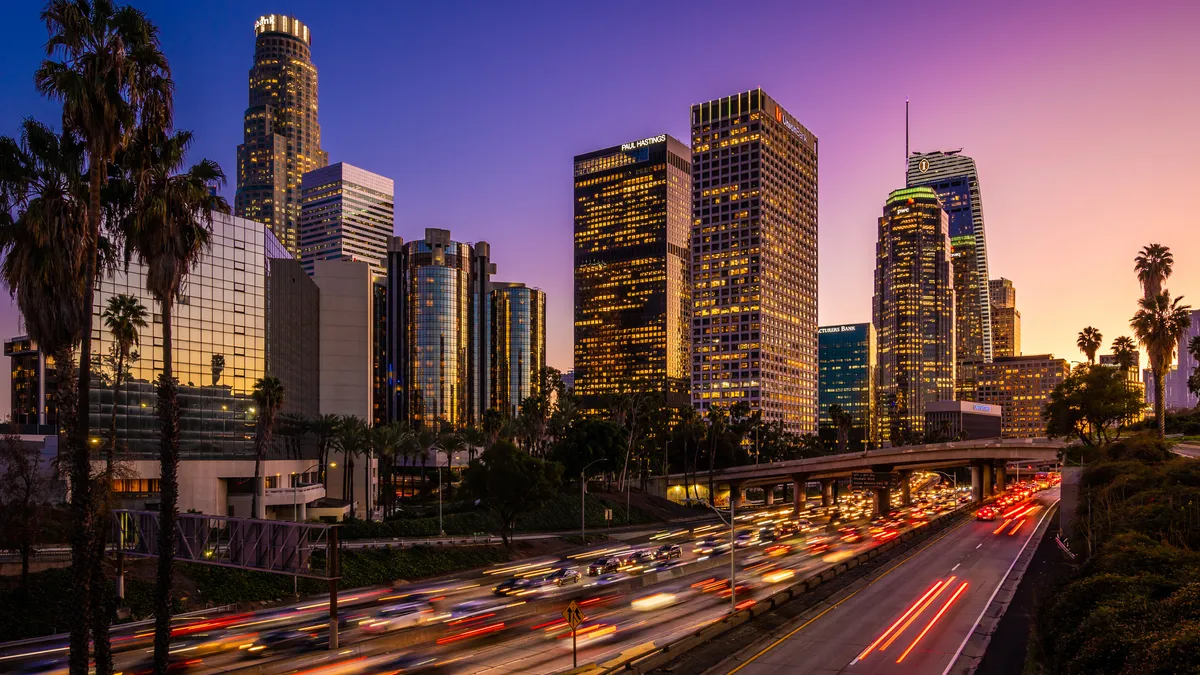 Busy traffic in Downtown Los Angeles at dusk.