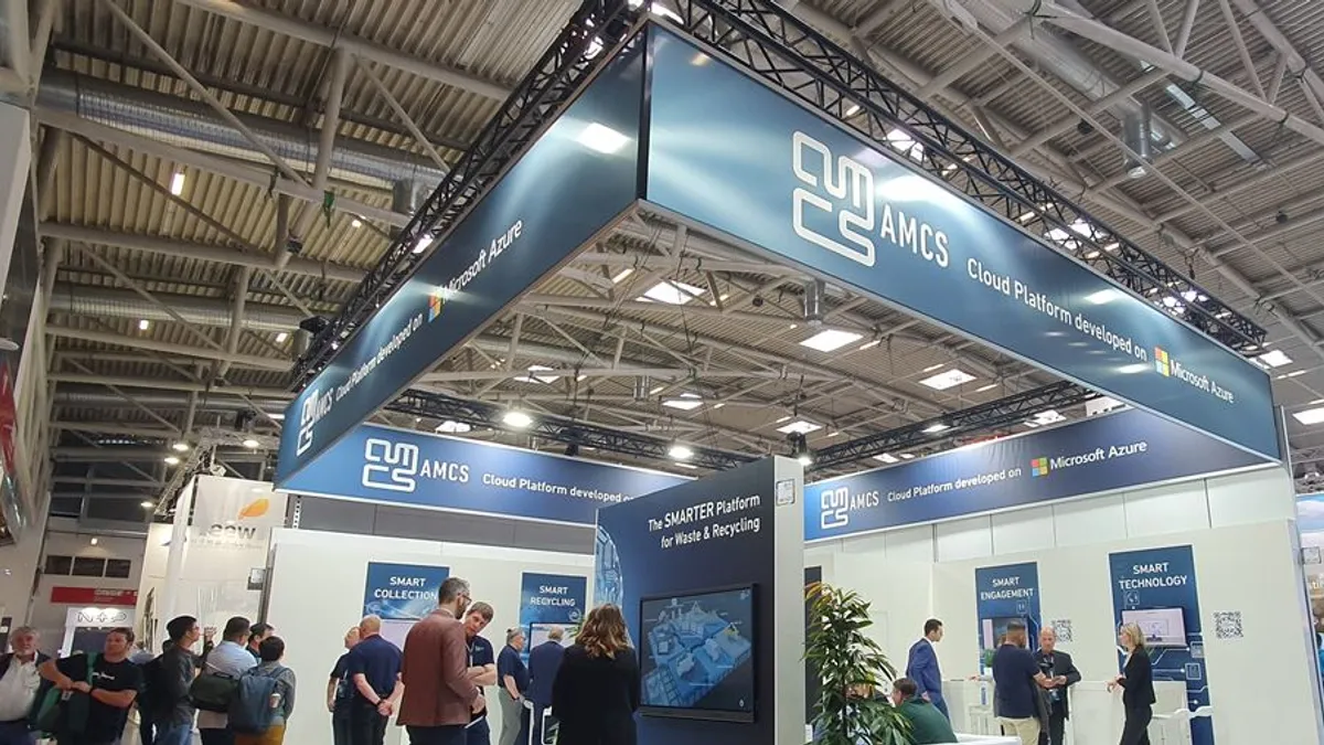 People standing around a trade show booth