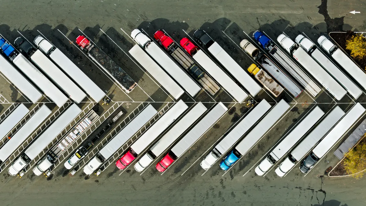 An aerial view shows the tops of trucks in a parking area.