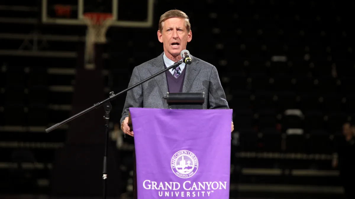 Brian Mueller, president of Grand Canyon University, speaks at a podium.