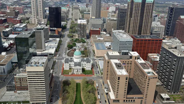Aerial view of tall buildings with a domed building in the center.