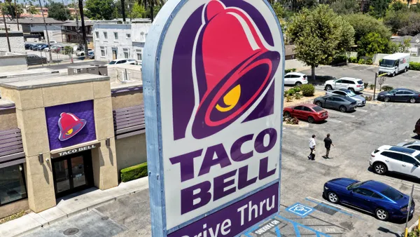 An aerial photograph of a Taco Bell sign next to a Taco Bell restaurant.