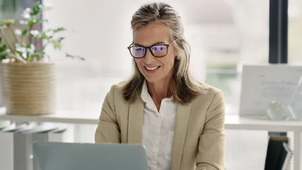 woman tea office mature businesswoman working on a laptop in an office