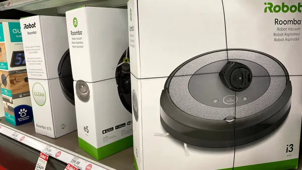 Roomba robot vacuums made by iRobot are displayed on a shelf at a Target store.