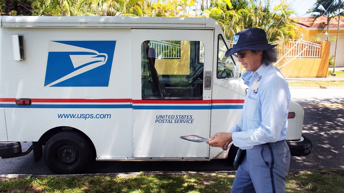 U.S. Postal Service mail carrier delivers mail.