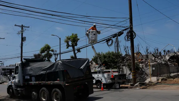 A utility worker repairs utility lines