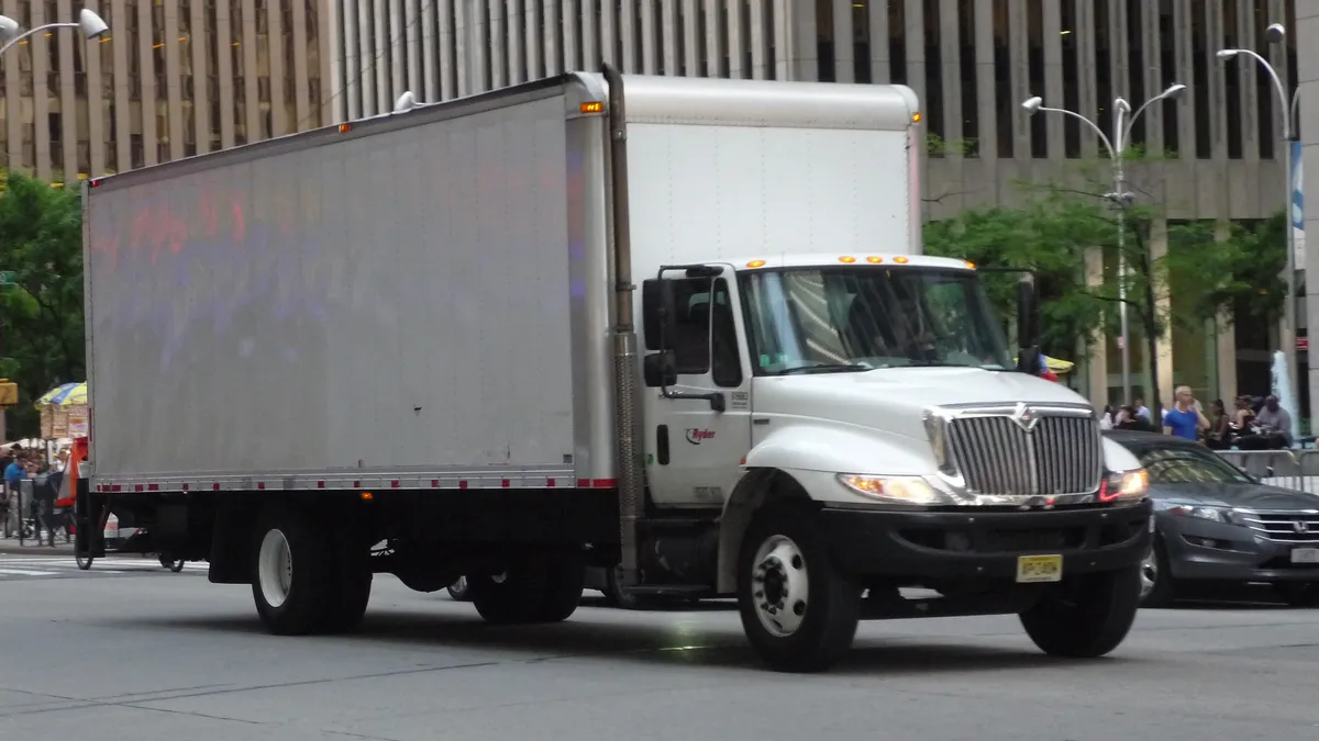 A Ryder truck on a street.