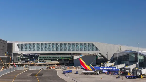On an airport tarmac and runway, a colorful plane emblazoned with "Southwest"