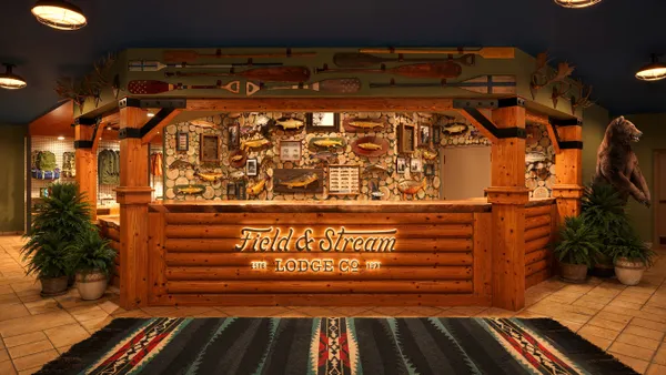 A wooden front desk displays the Field and Stream logo.