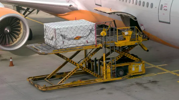Cargo is loaded into the belly of a passenger aircraft