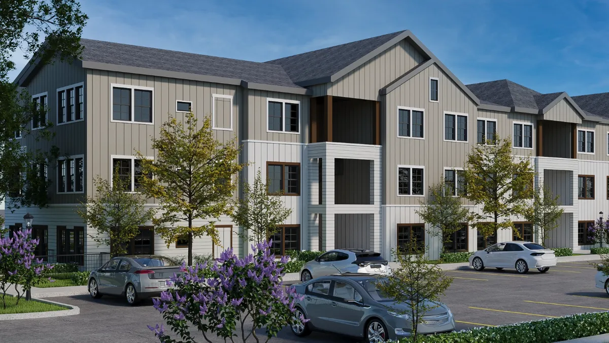 A garden-style apartment building with white siding.