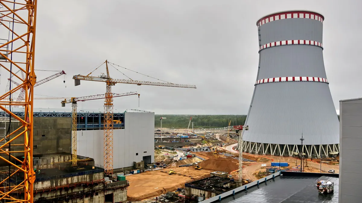 Construction cranes around a nuclear power plant.