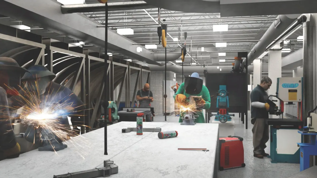 Three people at a white table wearing shields as they weld metal.