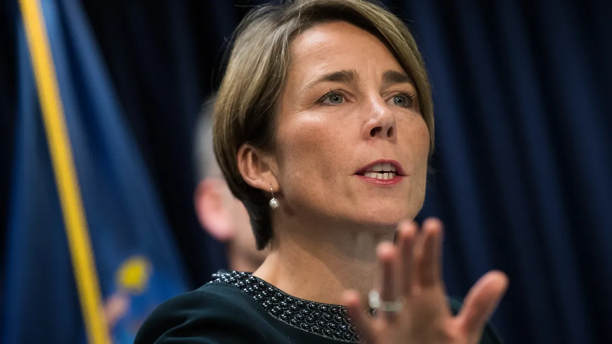 Maura Healey speaks into a microphone