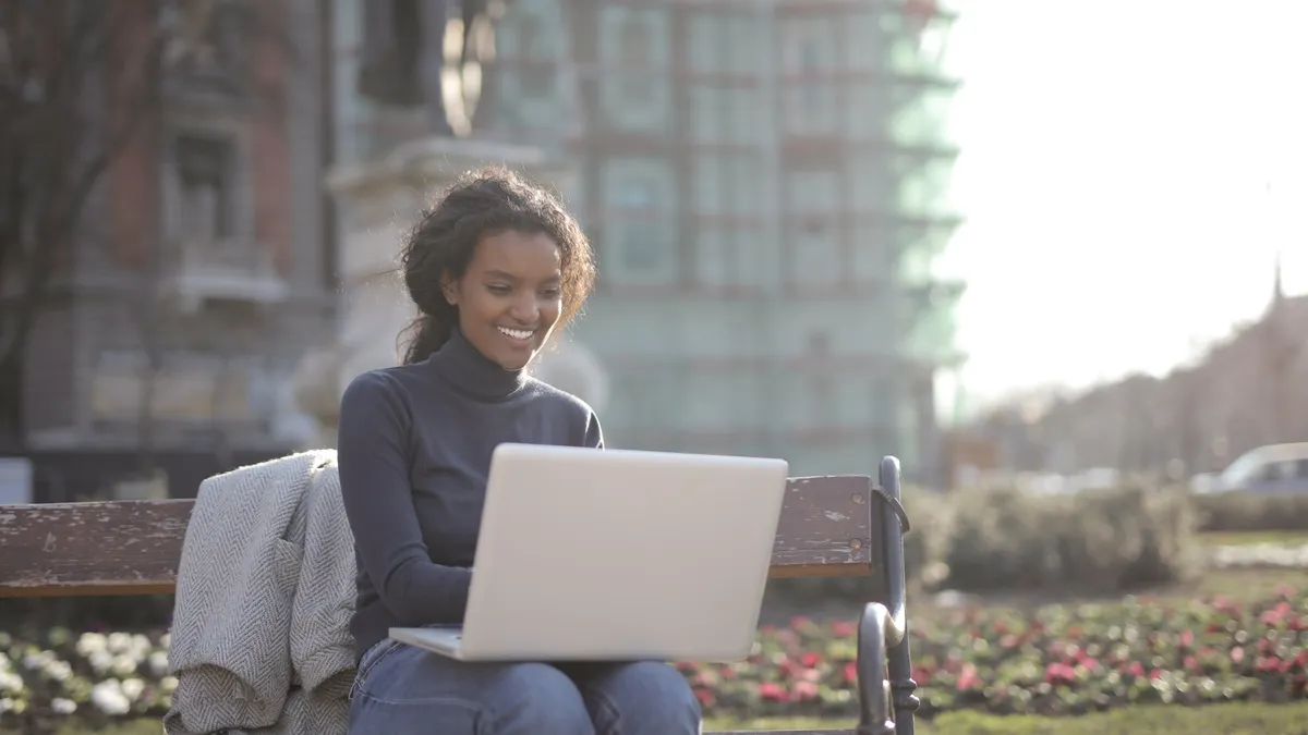 college student uses a laptop outside