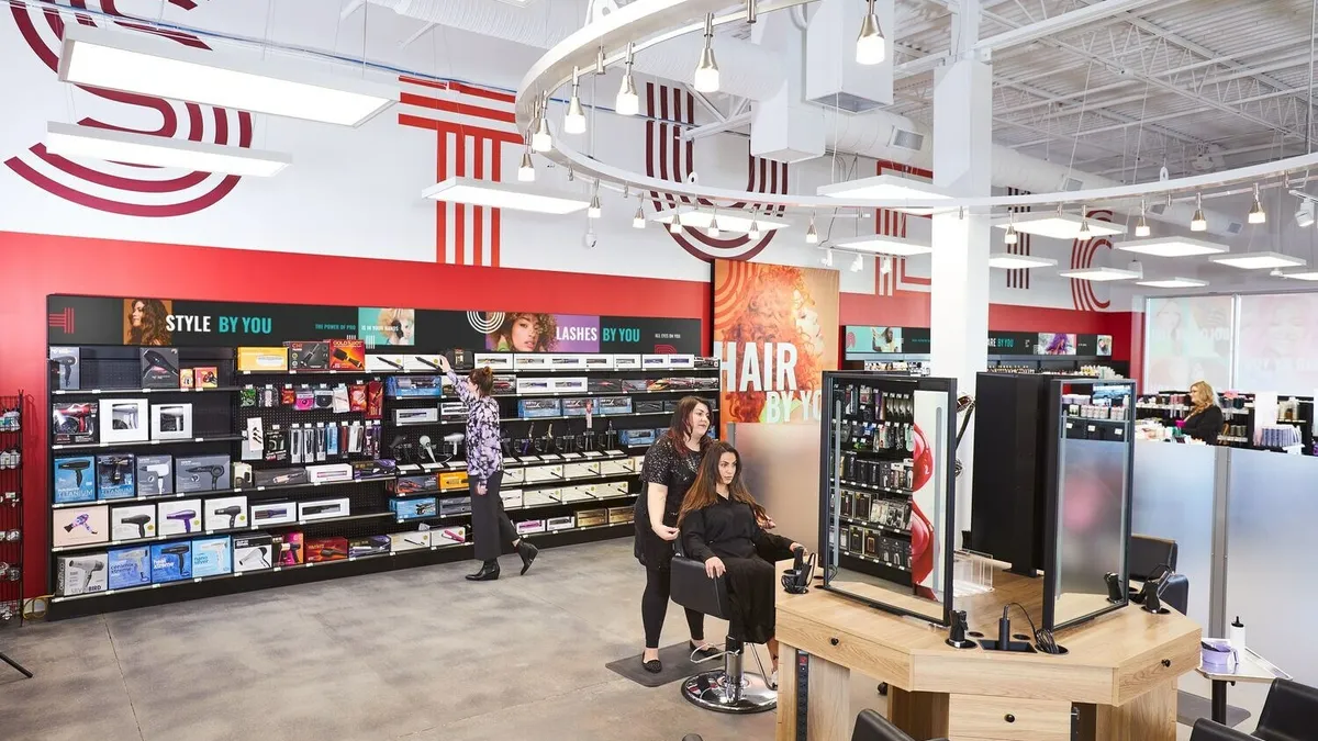 Inside of the Studio by Sally store with a person in a salon chair and shelves full of products.