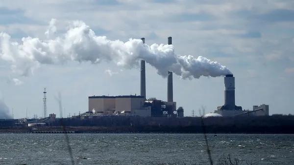 A coal-fired power plant by a river.