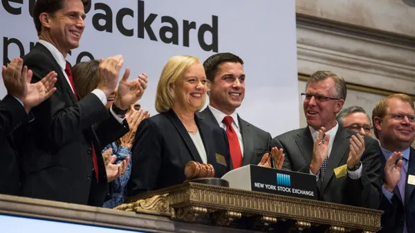A woman stands at a podium at the New York Stock Exchange.