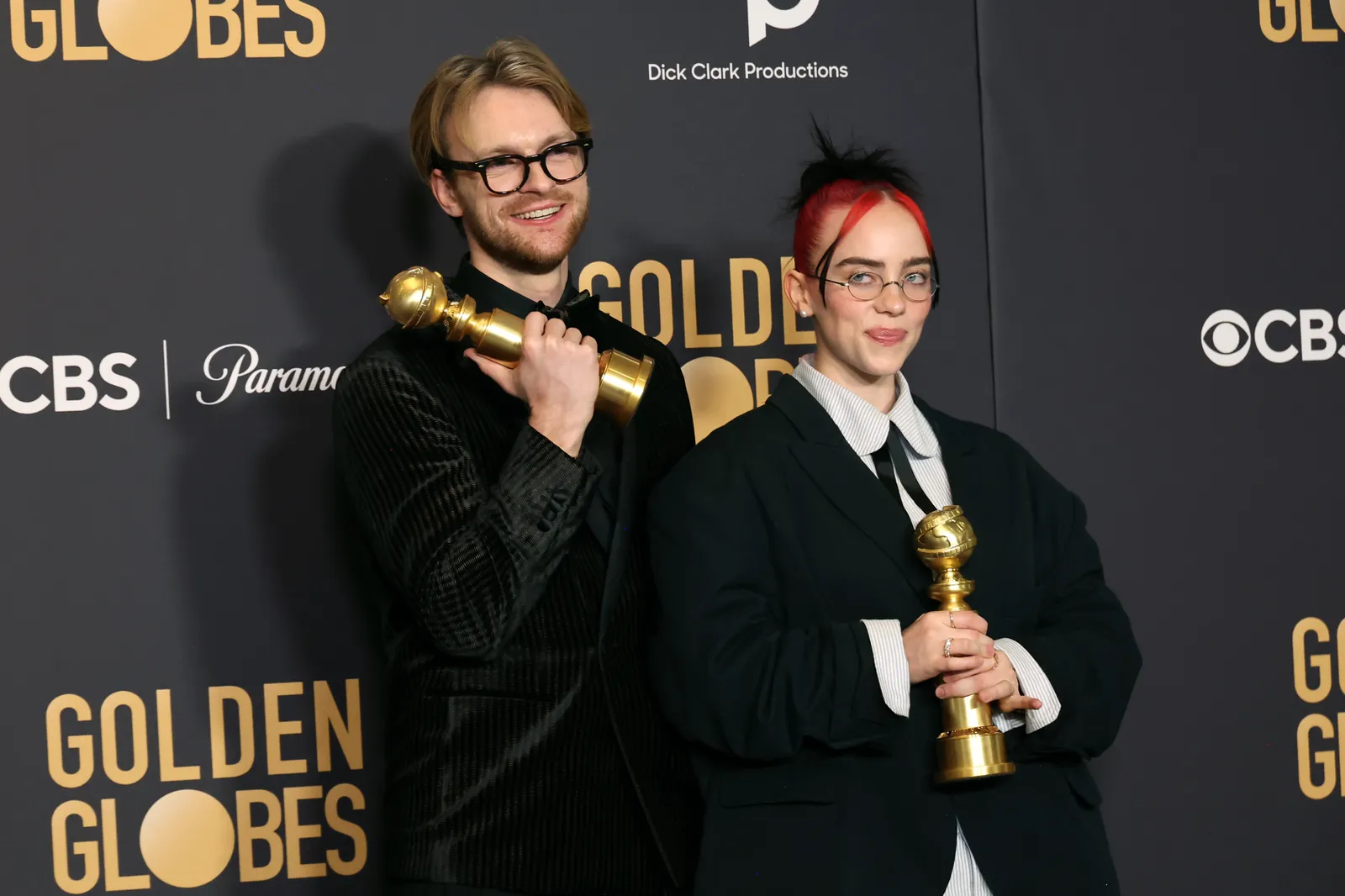 Finneas O’Connell and Billie Eilish pose with their Golden Globe awards.