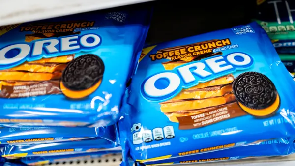 Packages of toffee crunch Oreo cookies displayed on a store shelf. The packages read "Toffee Crunch Flavor Creme Oreo."