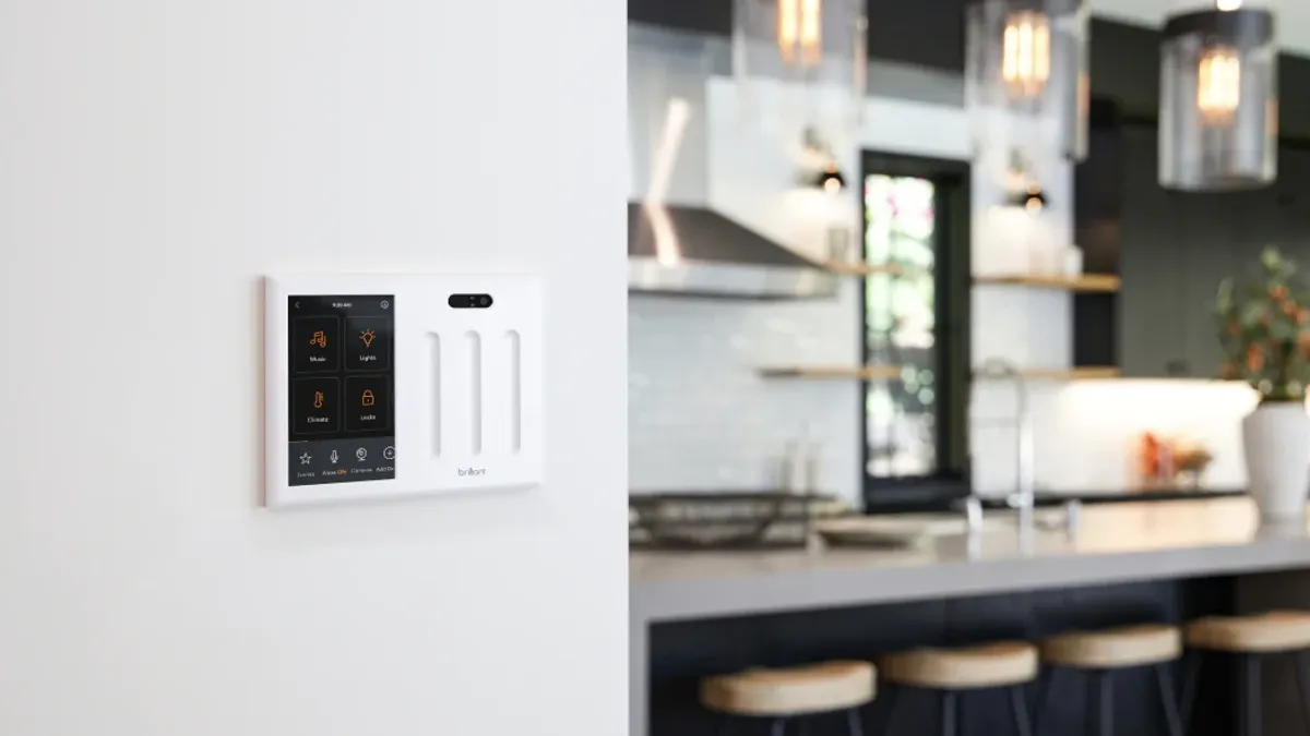 A smart light switch panel set into the wall of a home.